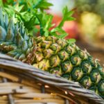 Close-up of a ripe pineapple in a basket, highlighting its fresh and juicy appeal.